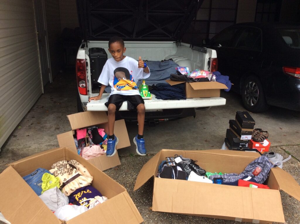 Leroy bringing boxes to flood victim stations at the Celtic Studios Shelter.