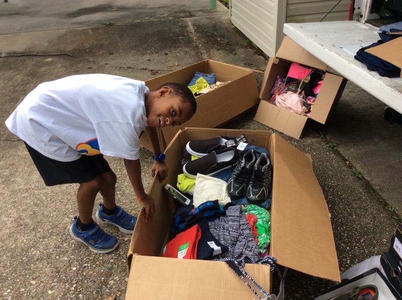 Leroy bringing boxes to flood victim stations at the Celtic Studios Shelter.