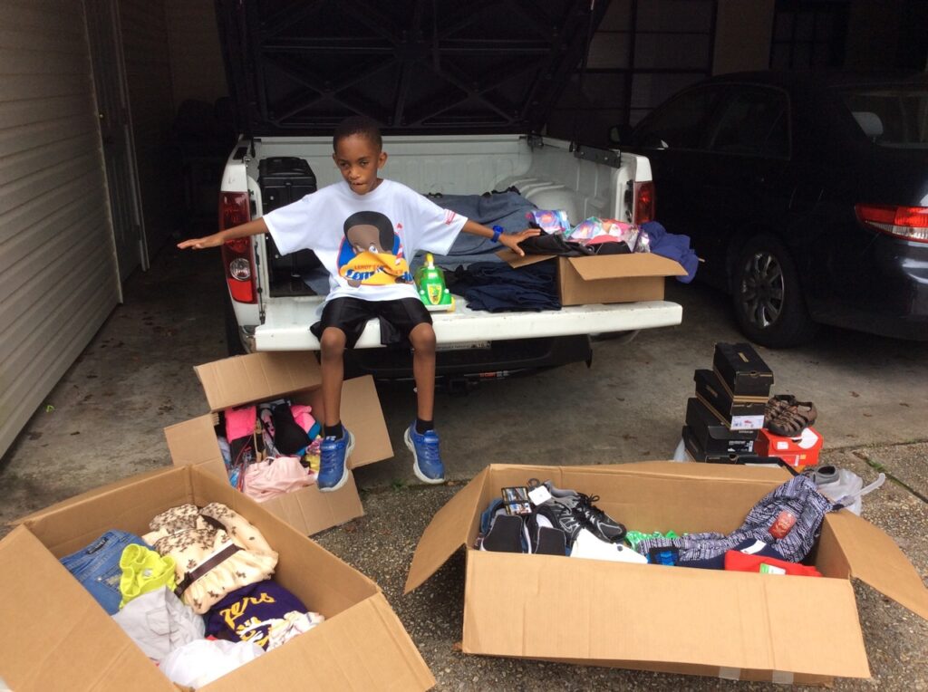 Leroy bringing boxes to flood victim stations at the Celtic Studios Shelter.